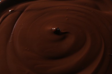 Photo of Tasty melted chocolate as background, closeup view