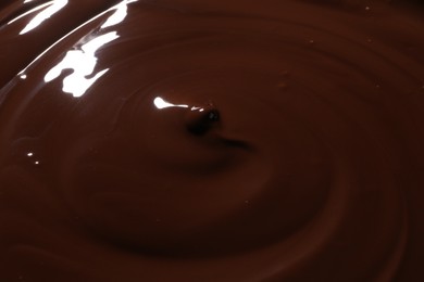 Photo of Tasty melted chocolate as background, closeup view