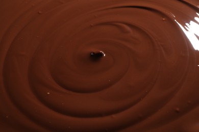 Photo of Tasty melted chocolate as background, closeup view