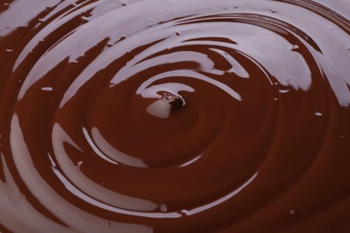 Photo of Tasty melted chocolate as background, closeup view