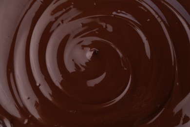 Photo of Tasty melted chocolate as background, closeup view