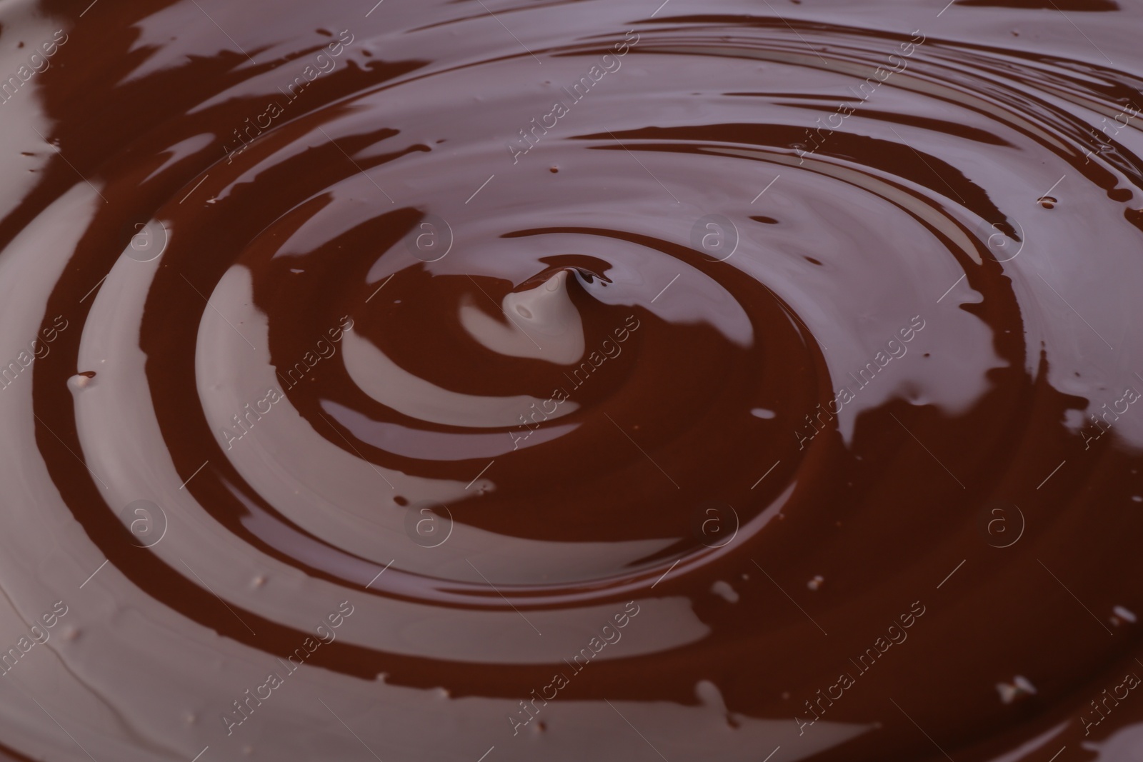 Photo of Tasty melted chocolate as background, closeup view