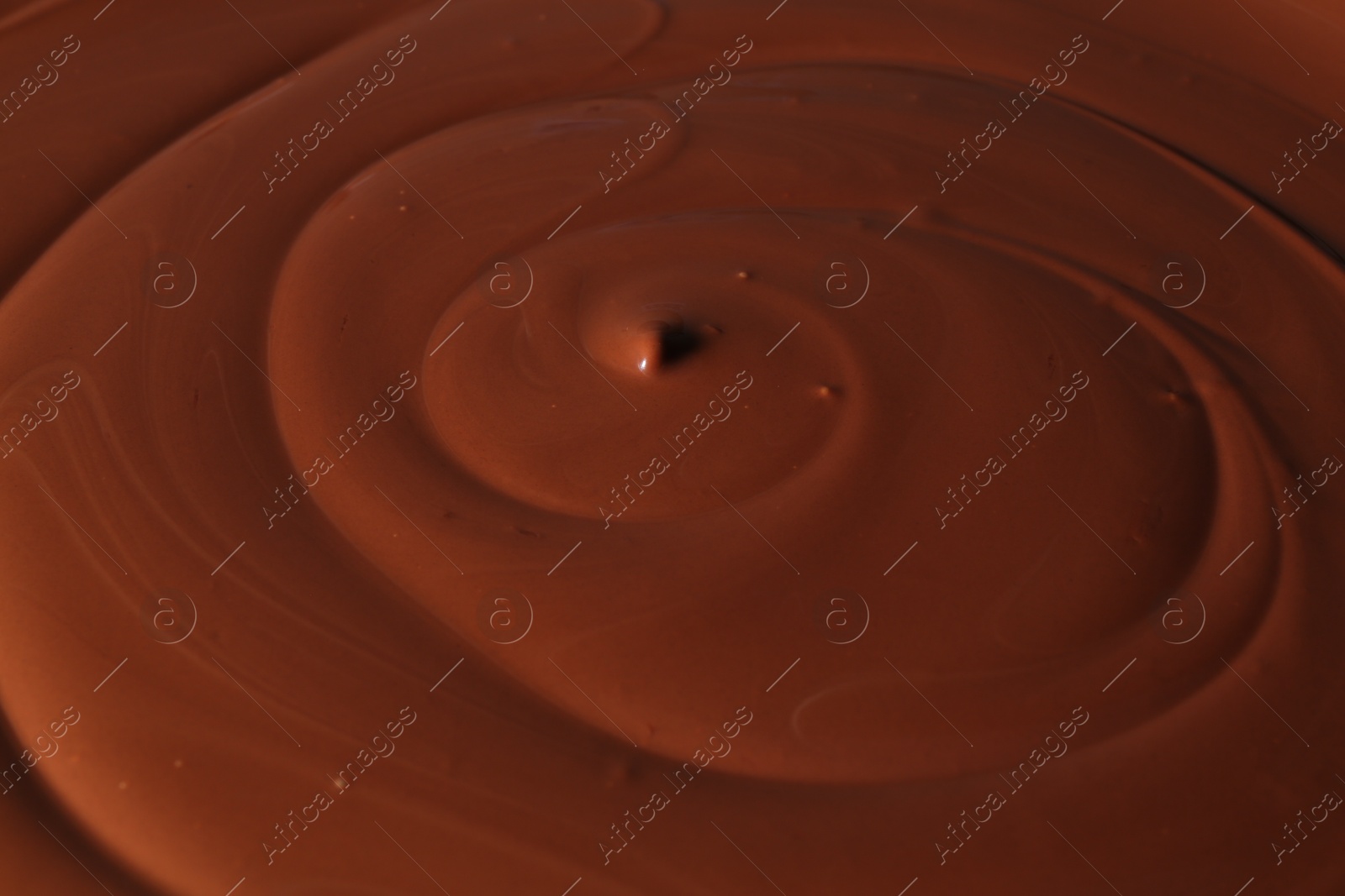 Photo of Tasty melted chocolate as background, closeup view