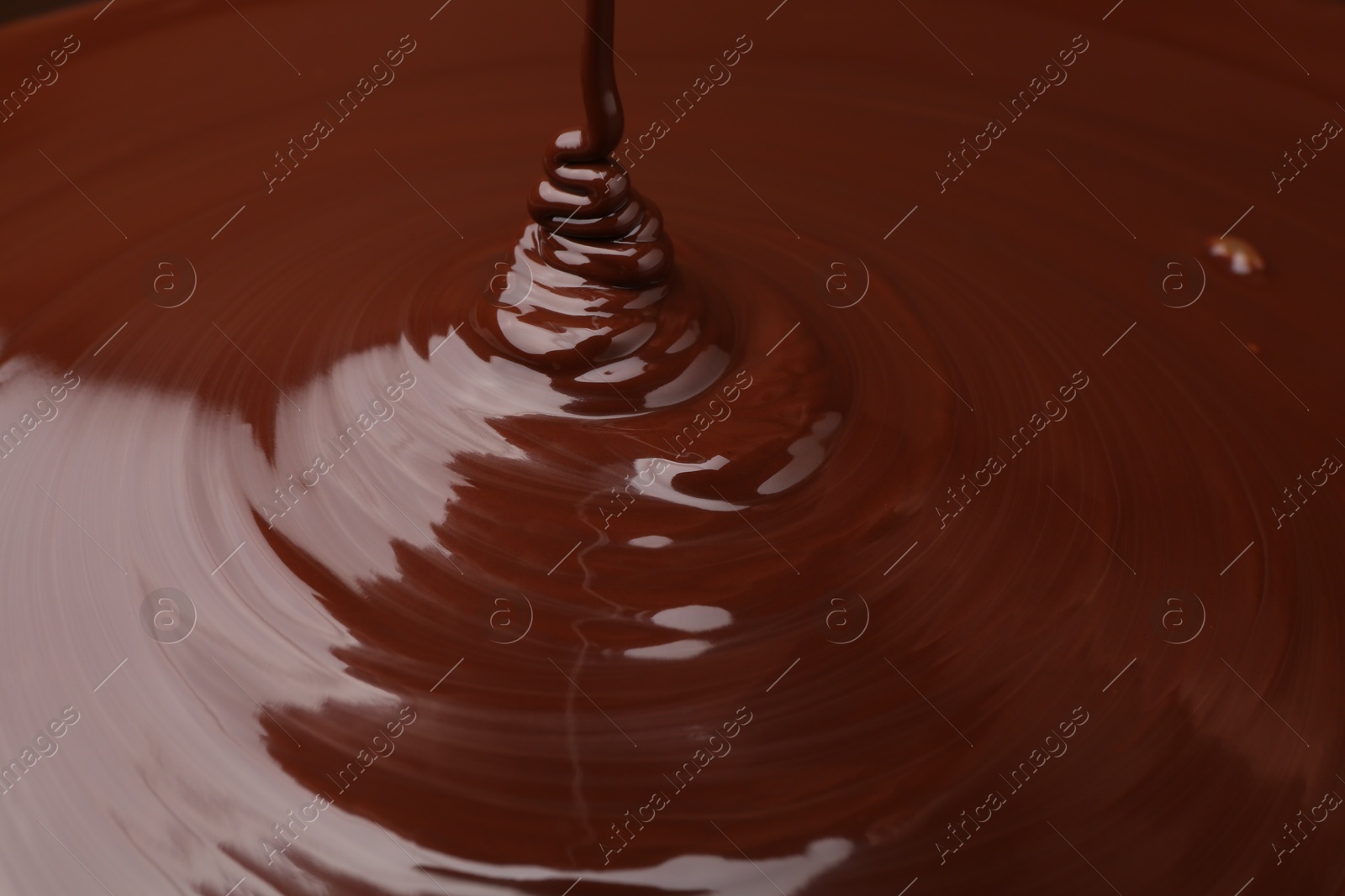 Photo of Closeup view of pouring delicious melted chocolate