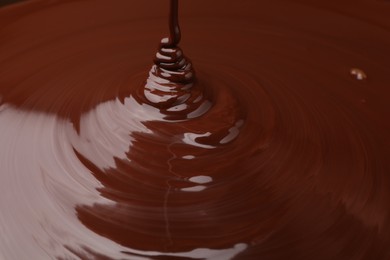 Photo of Closeup view of pouring delicious melted chocolate