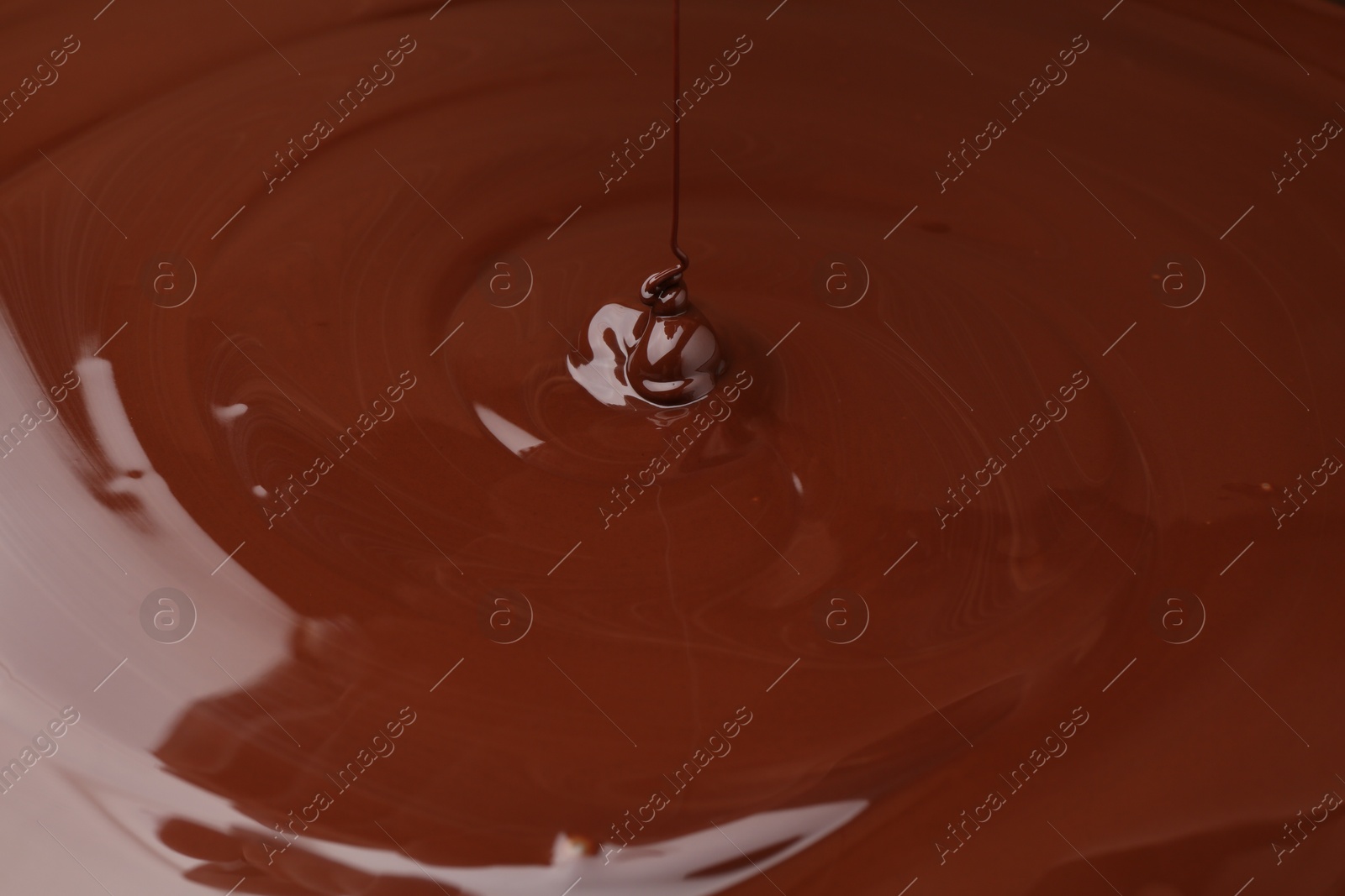 Photo of Closeup view of pouring delicious melted chocolate