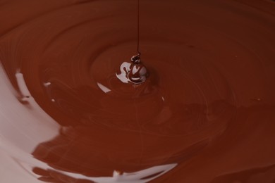 Closeup view of pouring delicious melted chocolate