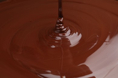 Photo of Closeup view of pouring delicious melted chocolate