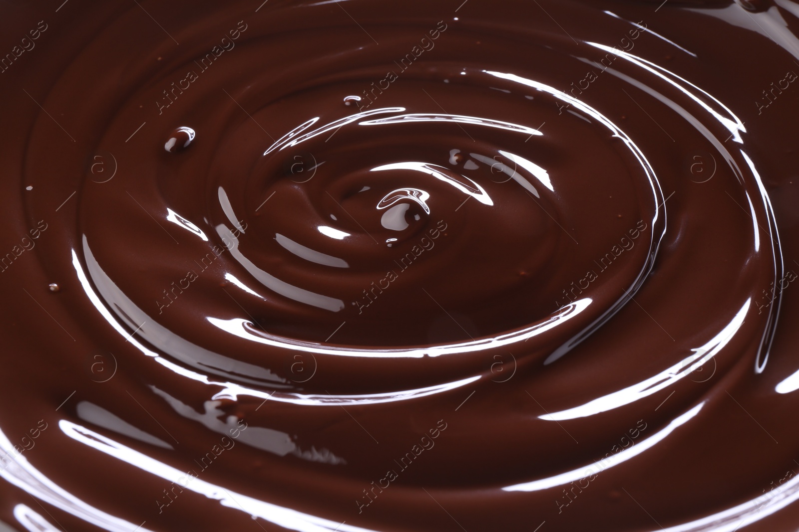 Photo of Delicious melted chocolate as background, closeup view