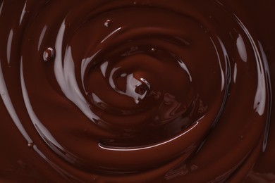 Photo of Delicious melted chocolate as background, top view