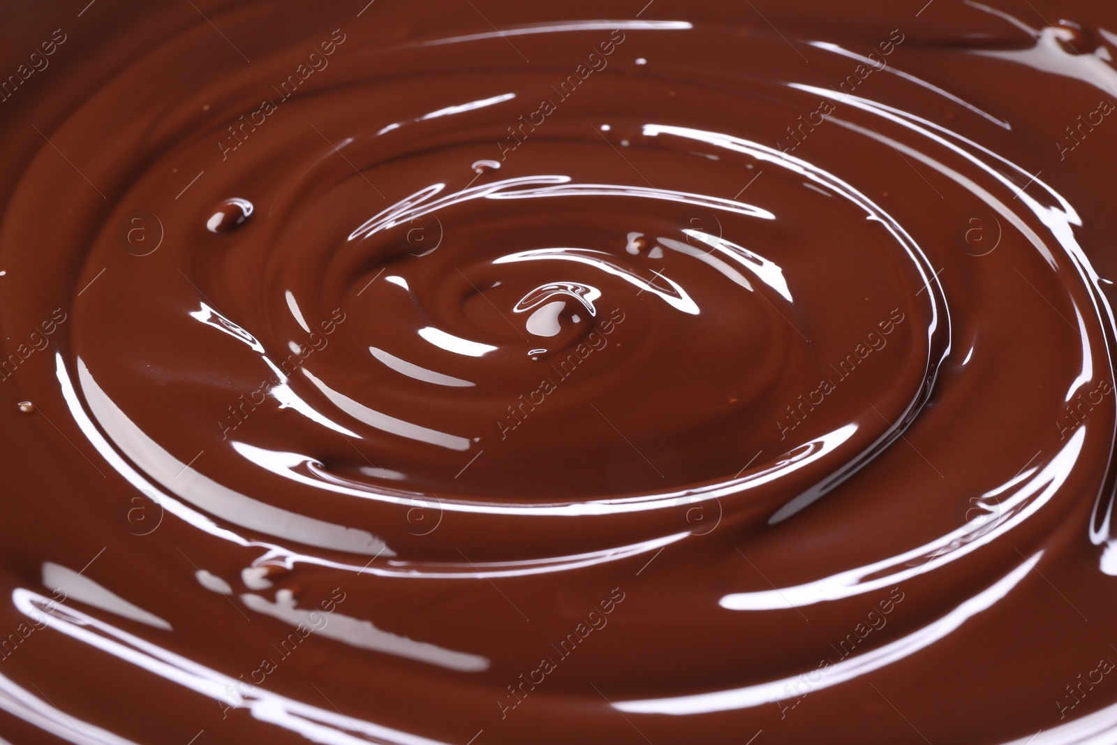 Photo of Delicious melted chocolate as background, closeup view