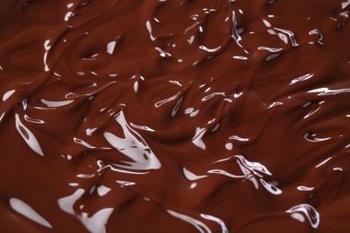 Photo of Delicious melted chocolate as background, closeup view