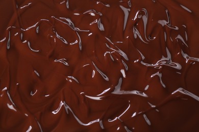 Photo of Delicious melted chocolate as background, top view