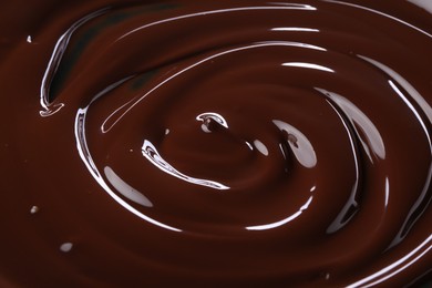 Photo of Delicious melted chocolate as background, closeup view