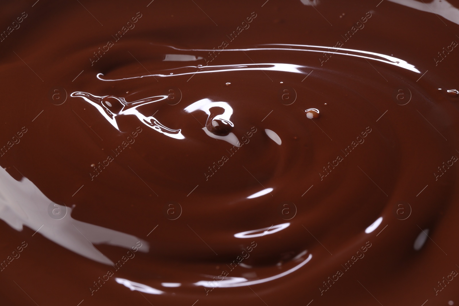 Photo of Delicious melted chocolate as background, closeup view