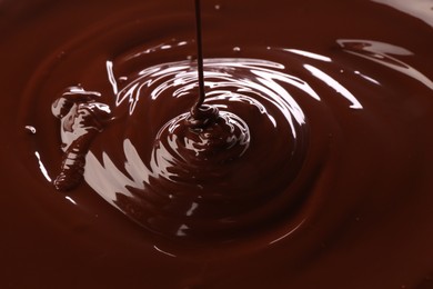 Photo of Closeup view of pouring delicious melted chocolate