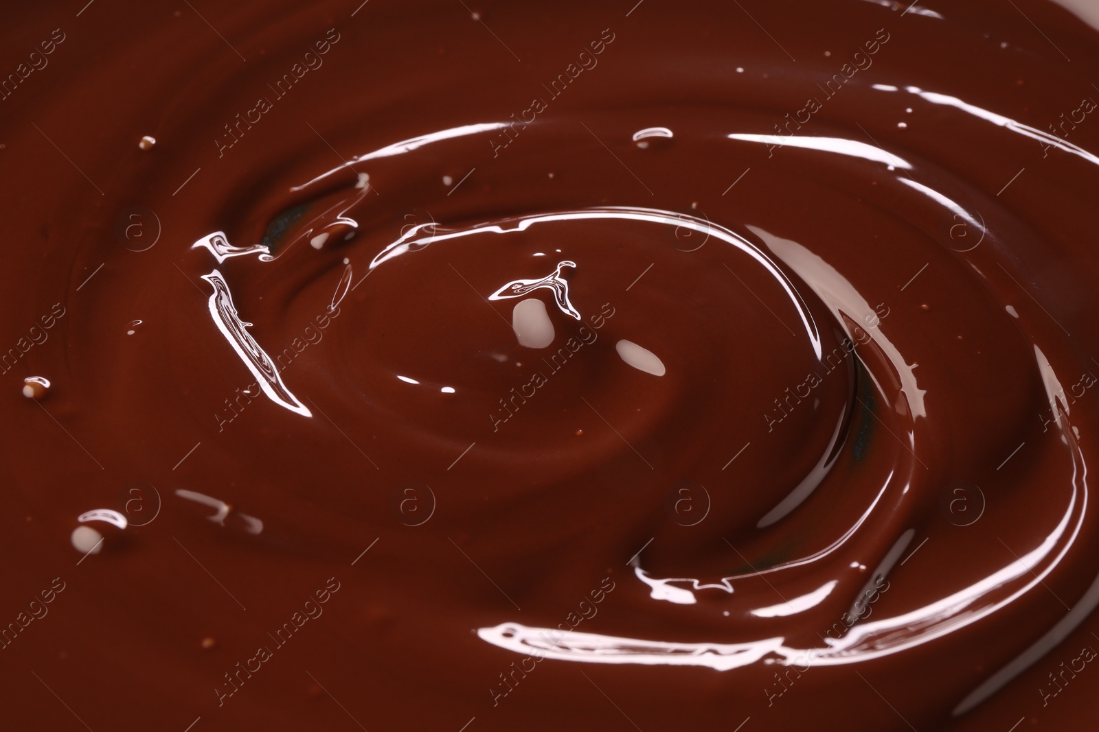 Photo of Delicious melted chocolate as background, closeup view