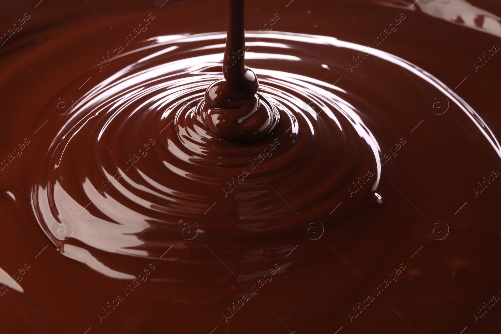 Photo of Closeup view of pouring delicious melted chocolate