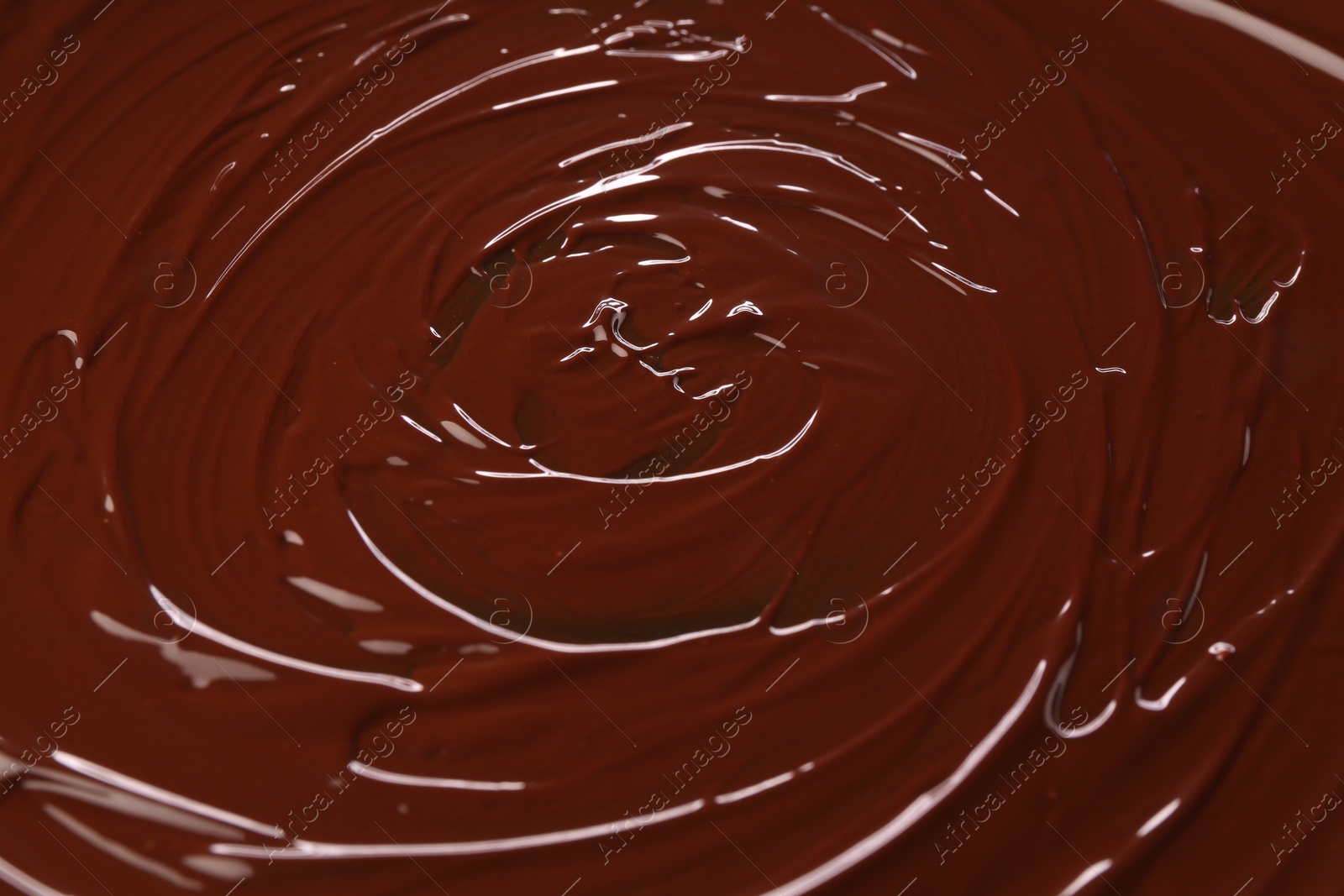 Photo of Delicious melted chocolate as background, closeup view