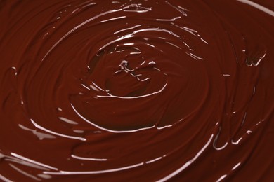 Photo of Delicious melted chocolate as background, closeup view