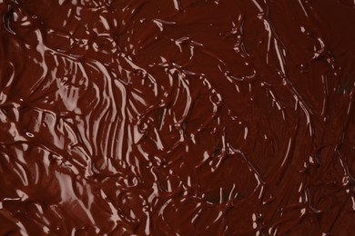 Photo of Delicious melted chocolate as background, top view