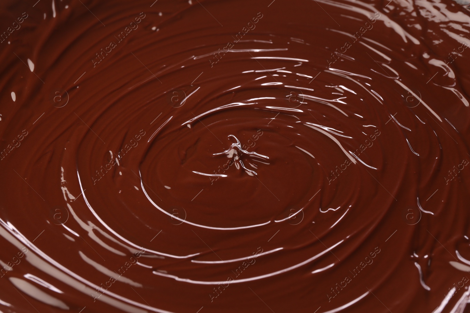 Photo of Delicious melted chocolate as background, closeup view