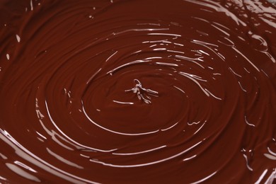 Photo of Delicious melted chocolate as background, closeup view