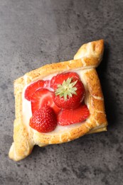 Tasty puff pastry with strawberries on grey table, top view