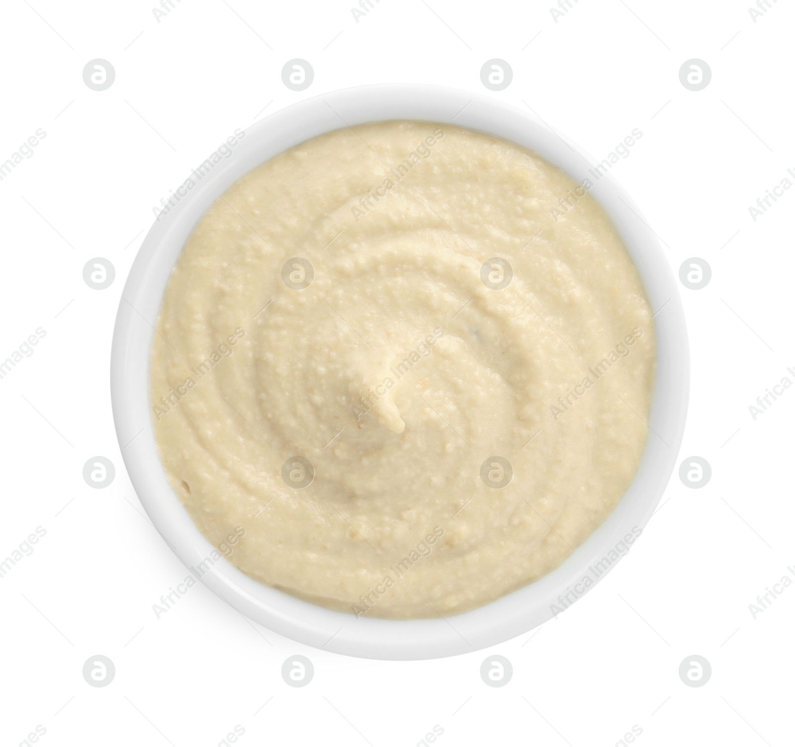 Photo of Delicious hummus in bowl isolated on white, top view