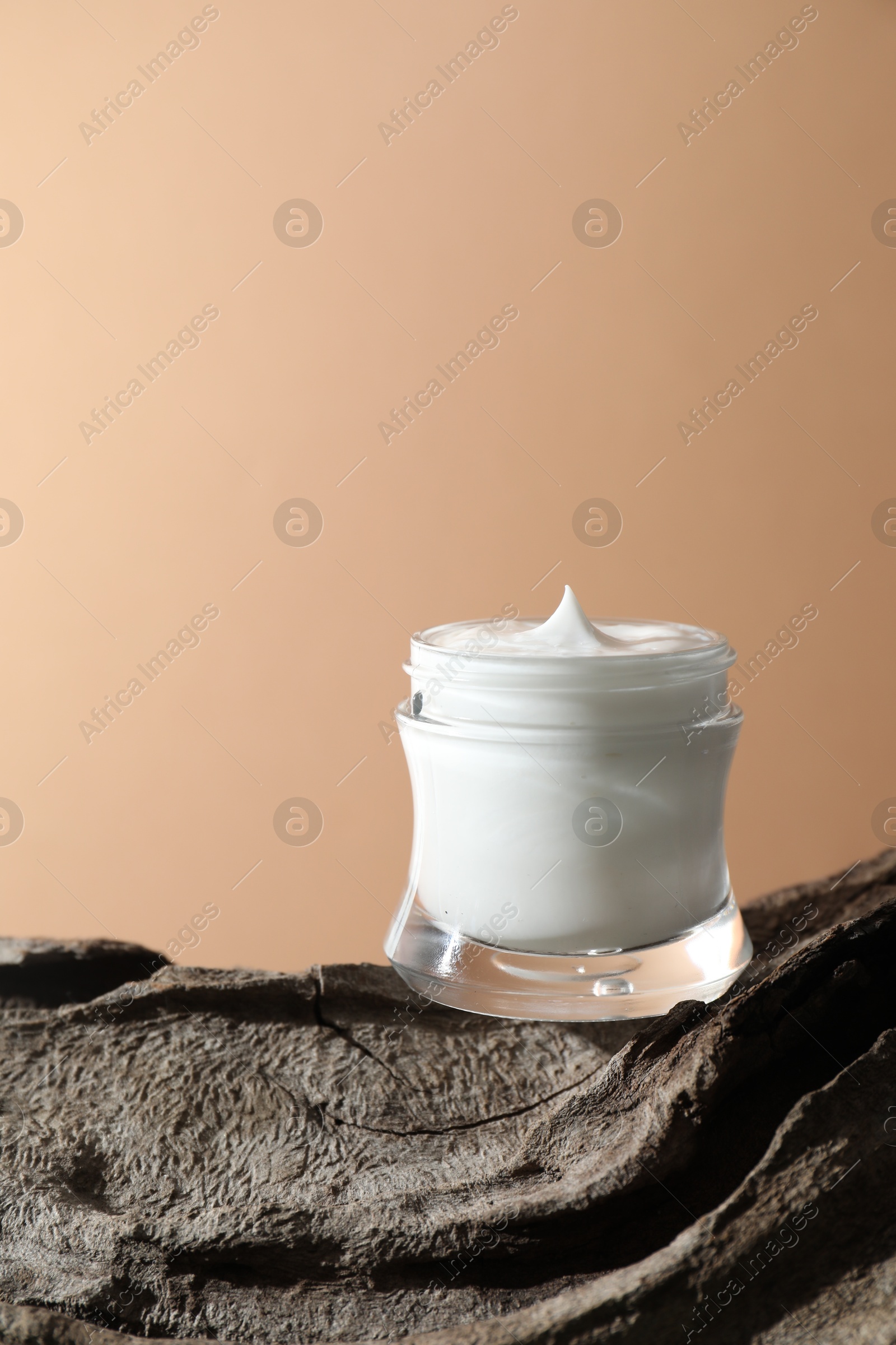 Photo of Stylish presentation of facial cream against beige background. Space for text