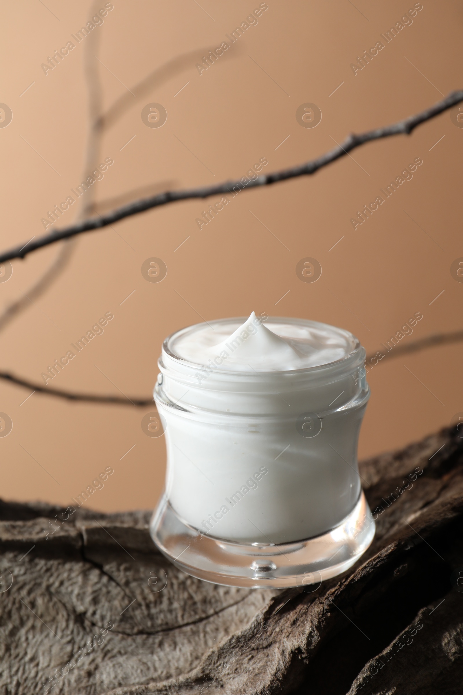 Photo of Stylish presentation of facial cream against beige background. Space for text