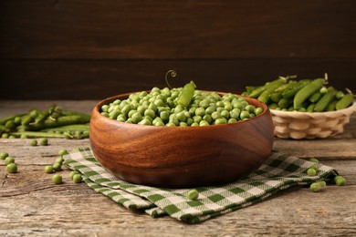 Photo of Fresh green peas and pods on wooden table