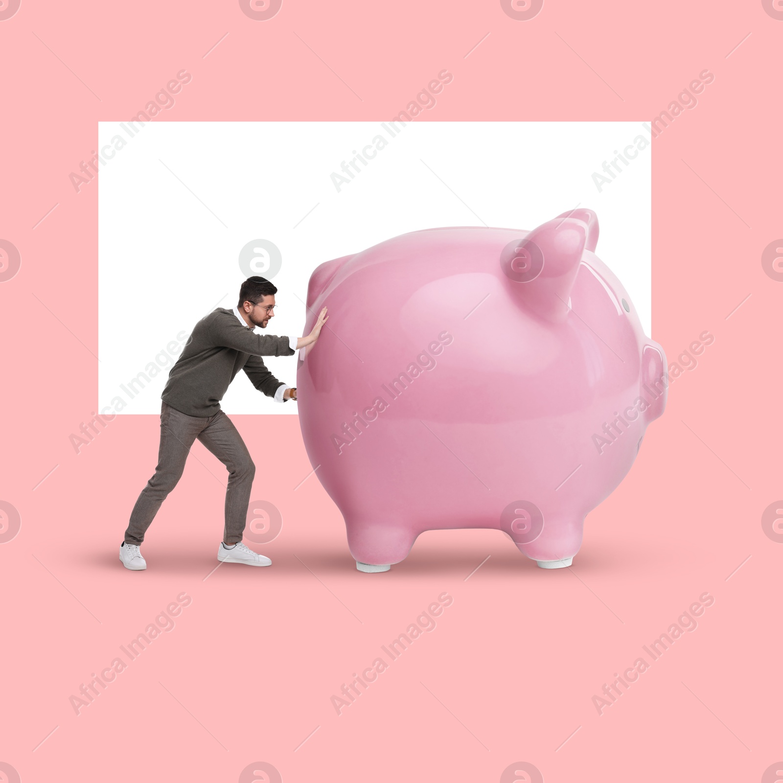 Image of Man pushing big piggy bank on color background. Creative collage