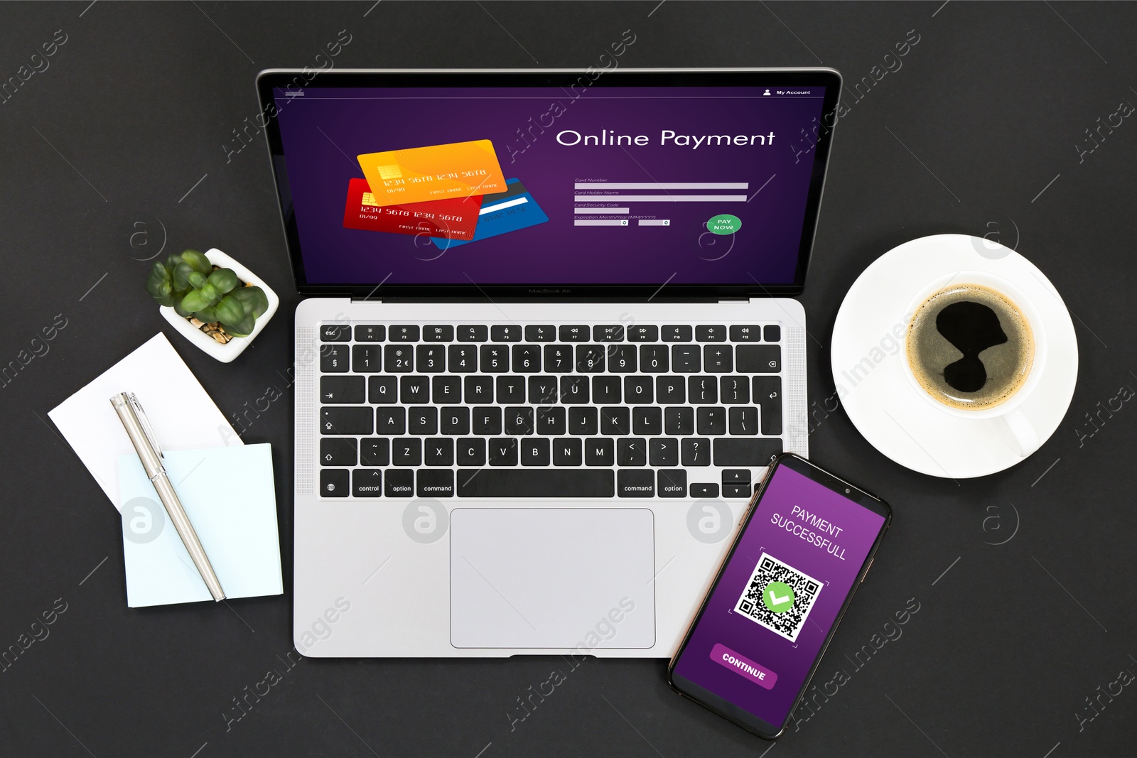 Image of Online payment system. Laptop and smartphone with open application on black table, top view