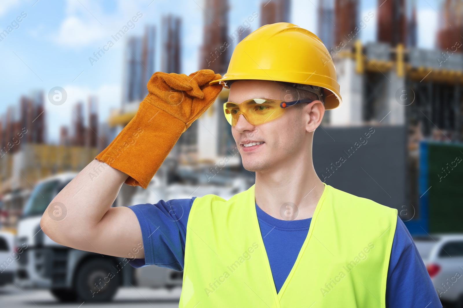 Image of Young man wearing safety equipment at construction site