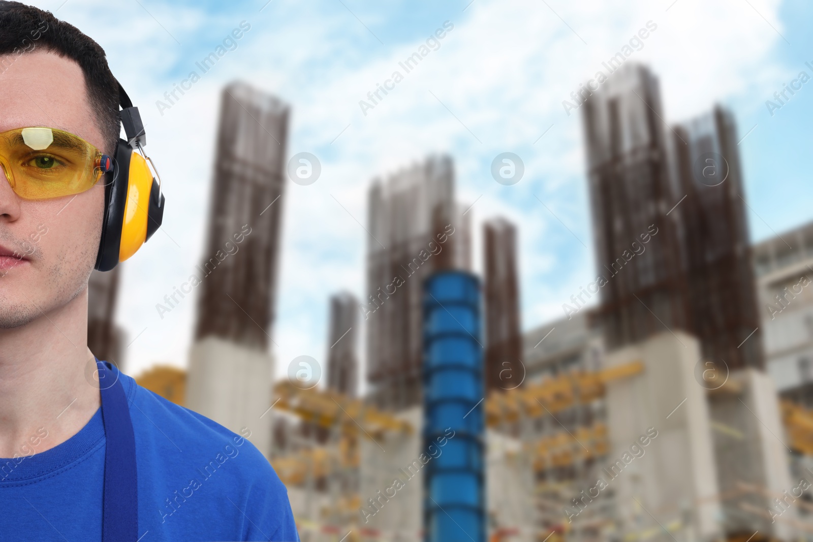 Image of Young man wearing safety equipment at construction site. Space for text