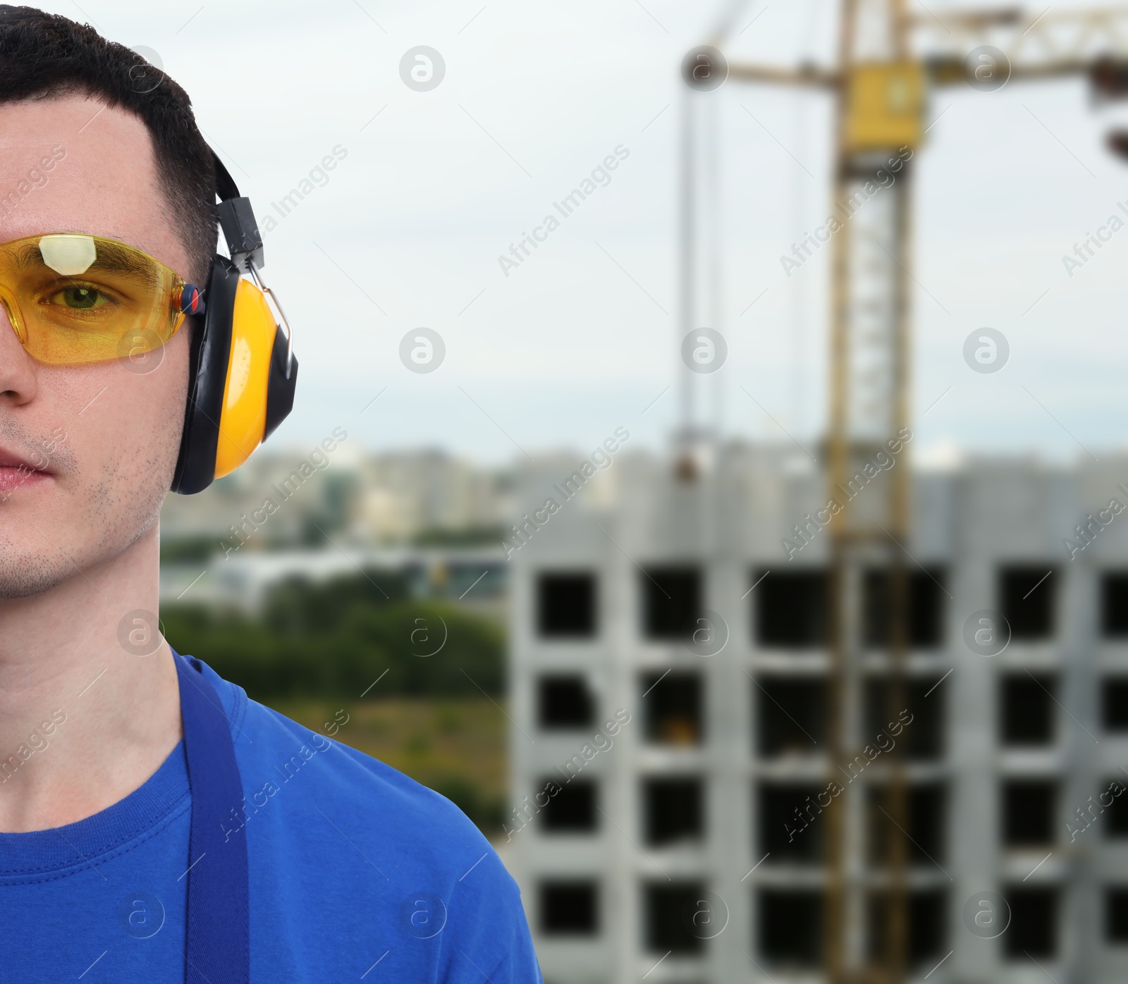 Image of Young man wearing safety equipment at construction site. Space for text