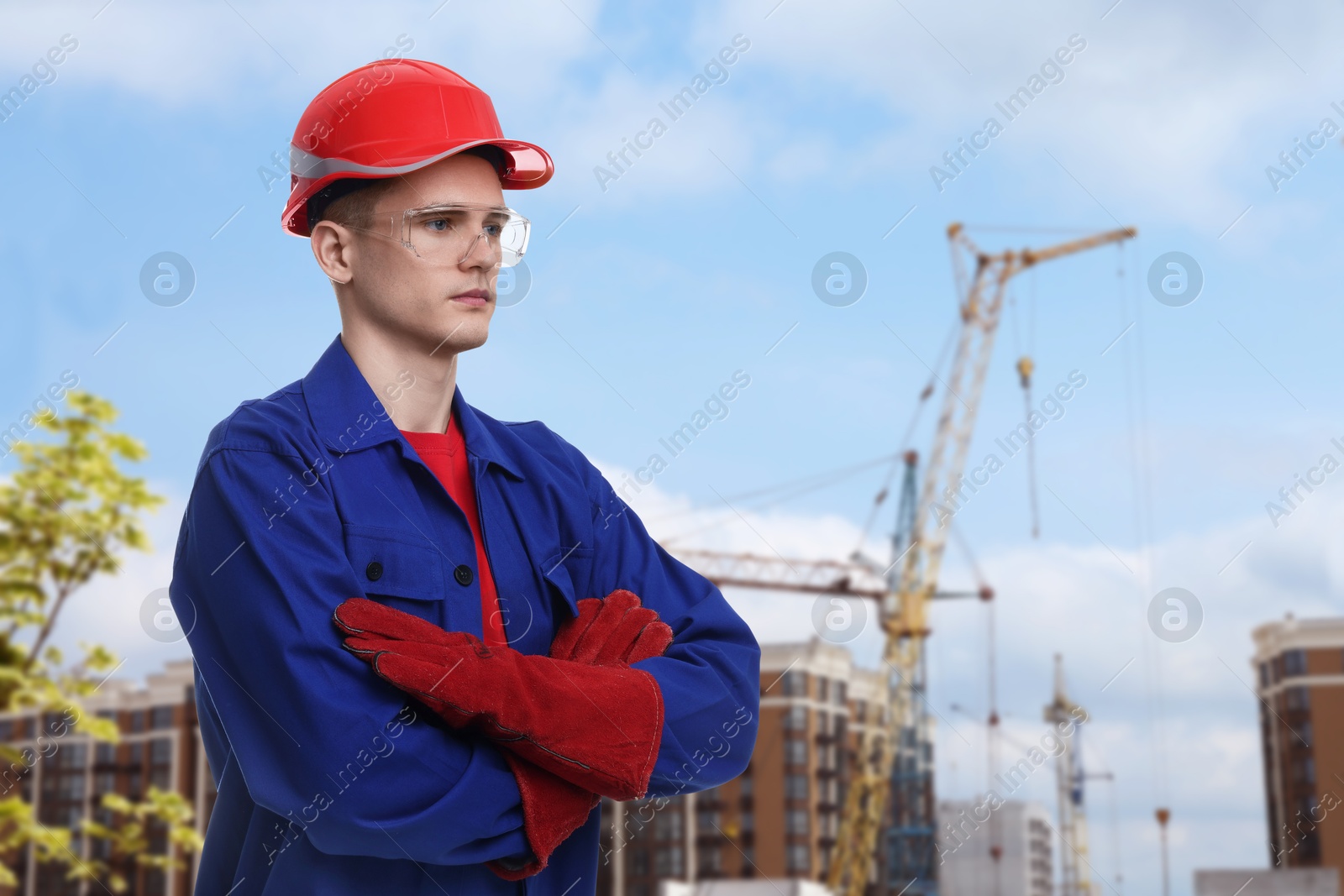 Image of Young man wearing safety equipment at construction site. Space for text