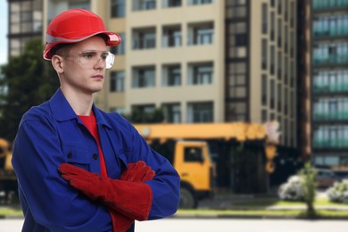 Image of Young man wearing safety equipment at construction site. Space for text
