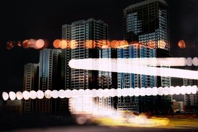 Image of City with buildings and blurred lights, double exposure