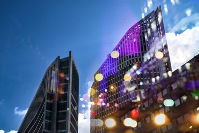 Image of City with buildings and blurred lights, double exposure