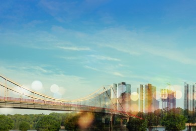Image of City with buildings, bridge and blurred lights, double exposure