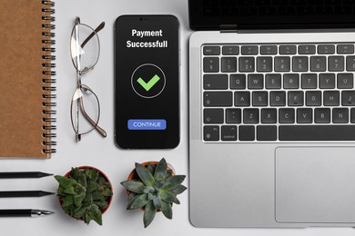 Image of Online payment system. Smartphone with open application on table, top view