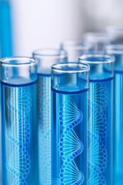 Image of Test tubes with illustrations of DNA in laboratory, closeup