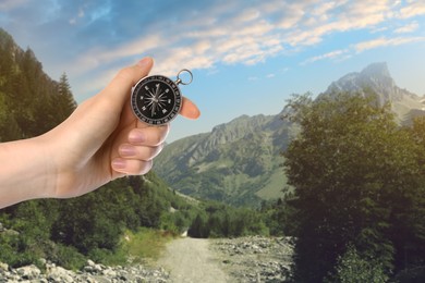 Image of Woman using compass in mountains, closeup. Navigational instrument