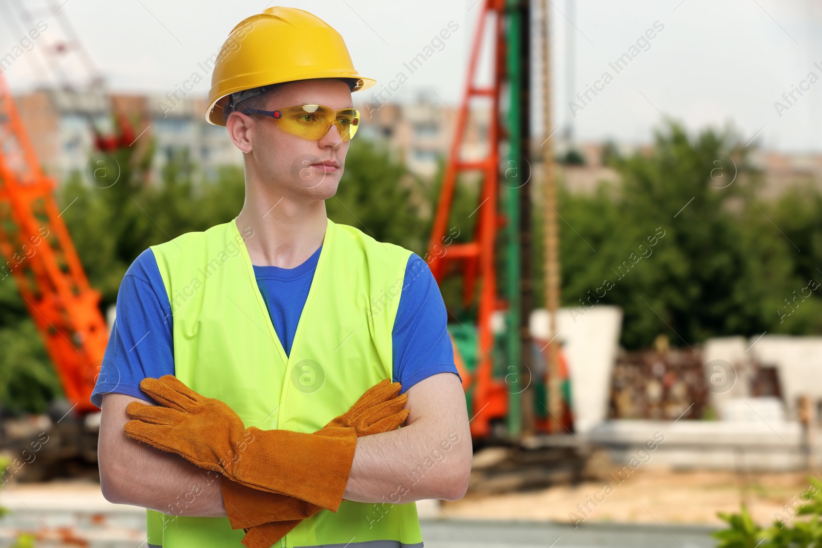 Image of Young man wearing safety equipment at construction site. Space for text