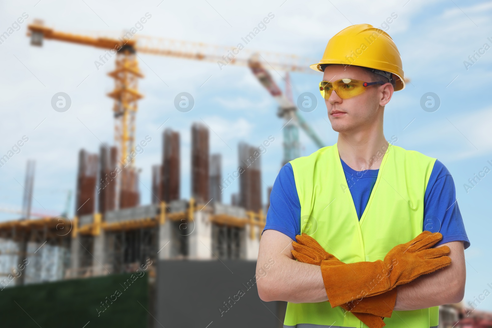 Image of Young man wearing safety equipment at construction site. Space for text