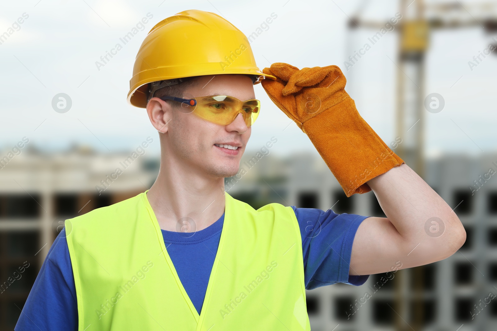 Image of Young man wearing safety equipment at construction site