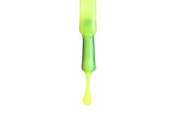 Photo of Bright nail polish dripping from brush isolated on white