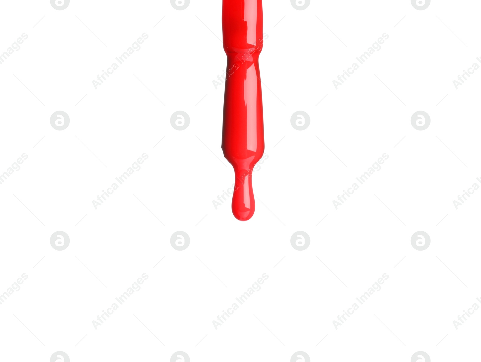 Photo of Red nail polish dripping from brush isolated on white